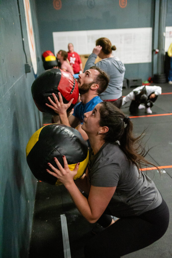 Members doing wall balls in a CrossFit class at Catoctin Fitness